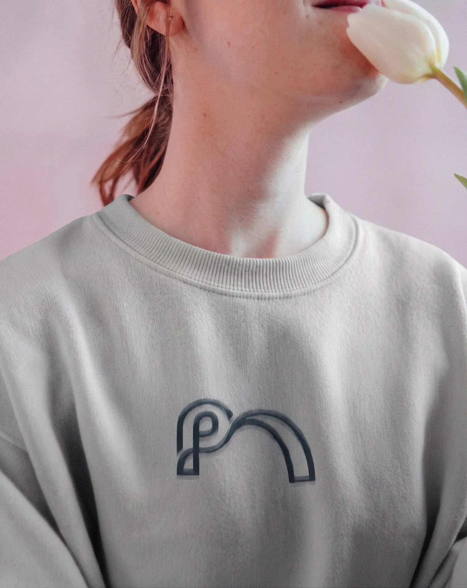 Praxis Assist mark embroidered on a sweatshirt