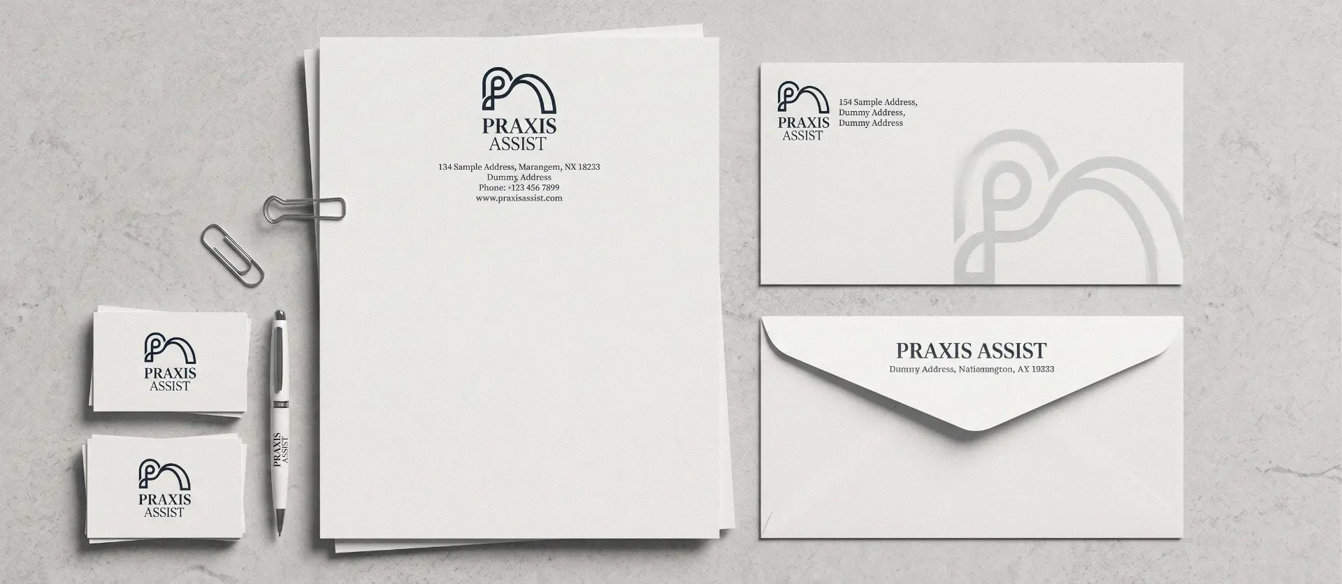 Praxis Assist letterhead, envelope and business card flatlay
