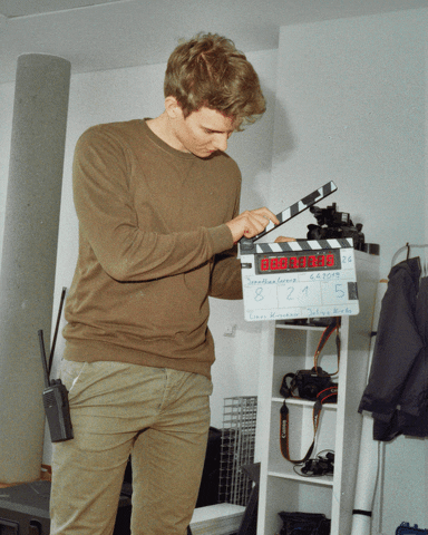 Filmmaker with clapperboard on set